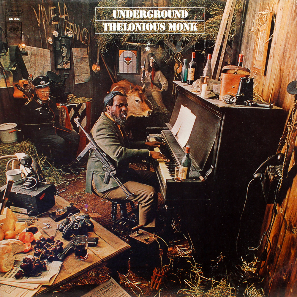 The cover art for Monk's album _Underground_: Monk is seated at a piano, surrounded by Nazi items taken as war
trophies, as well as general war paraphernalia. Behind him is a cow and a woman holding a gun.